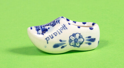 Miniature dutch wooden shoe souvenir on white background, typical dutch souvenir