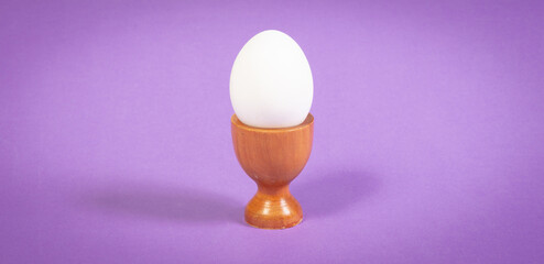 Wooden eggcup isolated on purple background