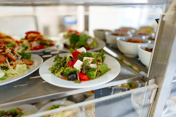 Freshly Prepared Salads on Display in a Cafeteria During Lunchtime