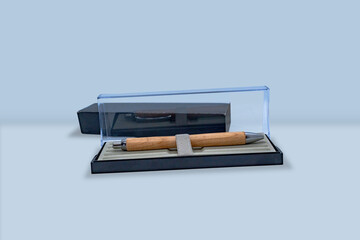 A very expensive looking wooden pen in a glass box