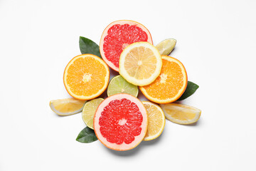 Different cut citrus fruits and leaves on white table, flat lay