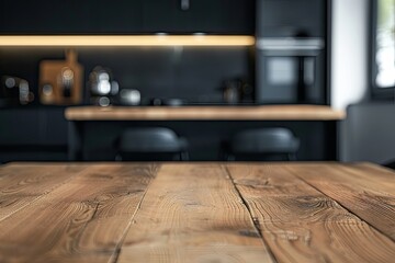 A copy space on a hardwood dining table in a modern black kitchen with kitchen appliances  - obrazy, fototapety, plakaty