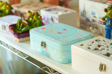 Colorful Childrens Lunch Boxes Displayed on Store Shelf in Daylight