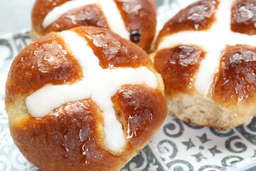 Tasty hot cross buns on table, closeup