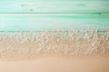 Beach sand and mint green wooden background with copy space for summer vacation concept, text on the right side