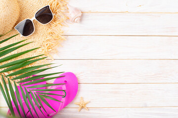 Vacation travel planning simple background of straw hat, sunglasses, palm leaves, flip flops and...