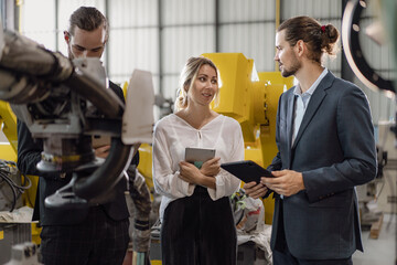 Businesswoman visit robotics engineering industry talking with engineer manager planning modern...
