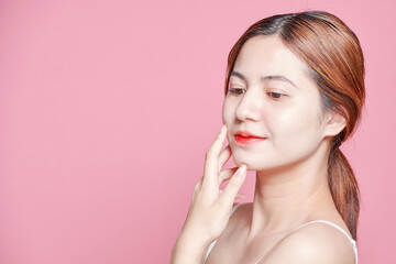 Beauty asian woman face portrait. beautiful model girl with perfect fresh clean skin color lips red. Facial treatment. Face care, Cosmetology , beauty and spa. Isolated on pink background.