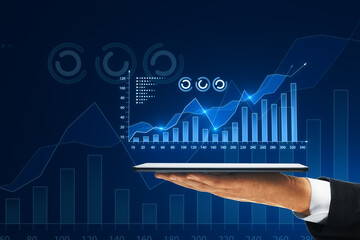 Close up of male hand holding smartphone with growing digital business chart on blue background. Business strategy development and growth plan.