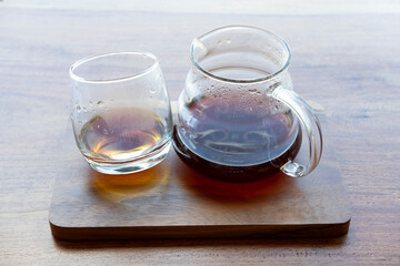 Pour over hot coffee serve with glass on wooden plate