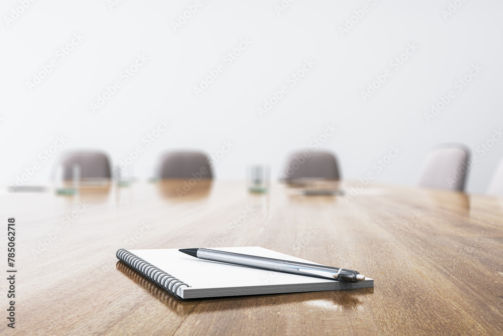 Poster Close up of wooden conference table with empty notepad and pen for morning notes. Blurry chairs in the backdrop. Business meeting concept. Mock up place, 3D Rendering.