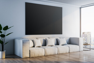 Modern concrete interior with sofa, wooden flooring,window and daylight, city view and plant. Empty black mock up banner on wall. 3D Rendering.