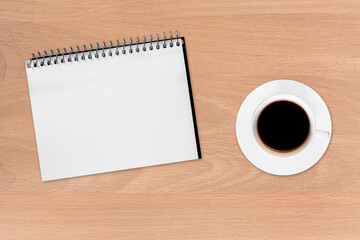 Coffee and notebook on the wood background