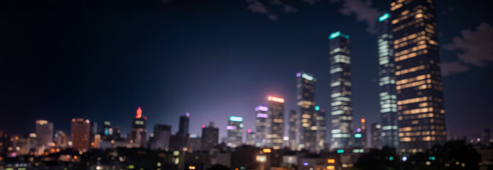 Abstract night lights of a modern futuristic cityscape. Defocused image, view of a dark modern urban skyline in the evening glow with many tall buildings, towers, skyscrapers with glowing windows.
