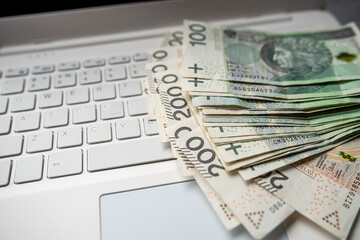 100 200 Polish PLN cash on laptop computer, make money or buy online - obrazy, fototapety, plakaty