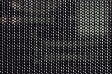 Structure of the metal mesh of the air filter on the front panel of the system unit of a modern computer. Background or backdrop. Photo - obrazy, fototapety, plakaty