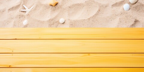 Beach sand and yellow wooden background with copy space for summer vacation concept, text on the right side