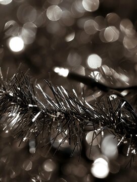 a small cluster of christmas lights made of tinsel, in the style of uhd image, fleeting moments, dark indigo and light bronze, creative commons attribution