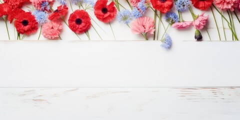 Fototapeta na wymiar Beautiful coral cornflower flowers on a white wooden background, in a top view with copy space for text