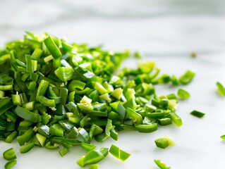 Cut chilli, close up, a pile of finely chopped green chili on a white marble countertop, soft diffused daylight highlighting the texture and color