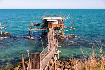 Traditional wooden fishing house with a net near sea coast - 785078108