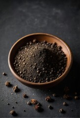 Black pepper powder on a black background.