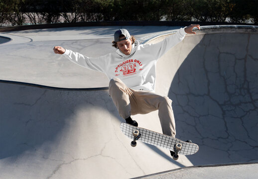 Mockup of man with customized sweatshirt skateboarding