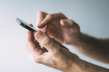 Man using smartphone to type text message