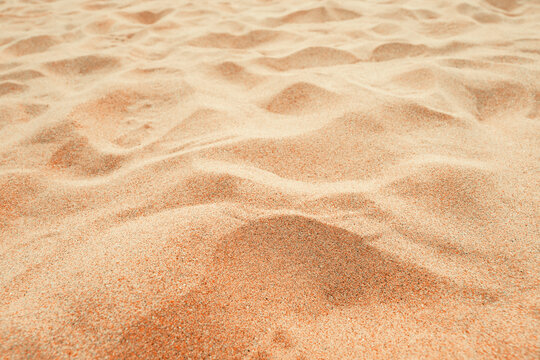 Fototapeta Beach sand background, close up, Low angle view of brown sandy surface in tropical resort. Vacation and summer holiday concept.