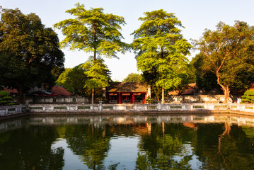 Van Mieu in Hanoi, Vietnam. Traditional asian building by a pond