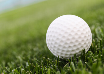 Game ball for playing golf on green grass
