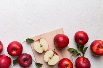 Fresh red apples with green leaves on table. cutting board with knife. Top view