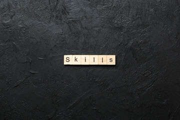 Skills word written on wood block. Skills text on cement table for your desing, concept