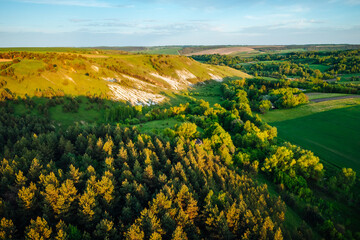 Picturesque summer scene of a rolling hills of rustic area from a bird's eye view.