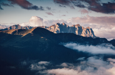 A gorgeous view of rocky peaks surrounded by fog. Italian Alps, Dolomites, South Tyrol, Europe. - 785090329