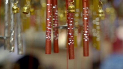 Close-up wind Chimes hangs on the porch of the house. Group of wind Chimes hanging on a festival