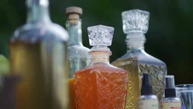 Close-up of different classic glass bottles with alcoholic drinks on the bar counter