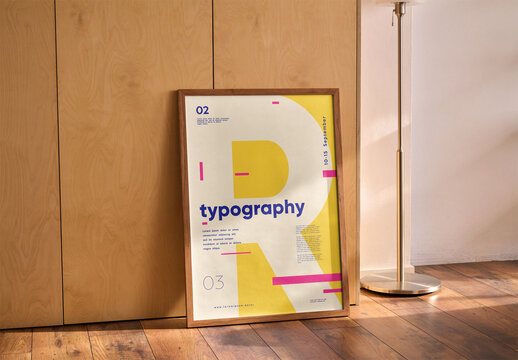 Mockup of vertical customizable wood poster frame leaning by wall
