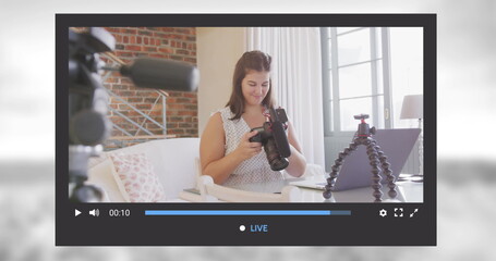Naklejka na ściany i meble Image of social media screen over caucasian woman with camera at home