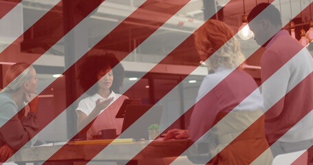 Image of flag of usa over diverse business people in office
