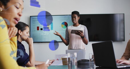 Image of data processing over diverse business people talking in office