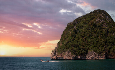 Cliff and the clear sea with boat  Phi Phi island in south of Thailand on sunset