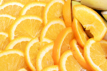 Assorted citrus fruit slices with a banana in the background