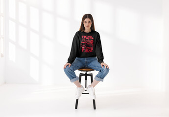 Mockup of woman wearing customizable sweatshirt on stool - obrazy, fototapety, plakaty