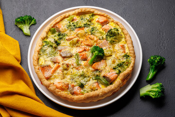 Homemade pie with salmon and broccoli