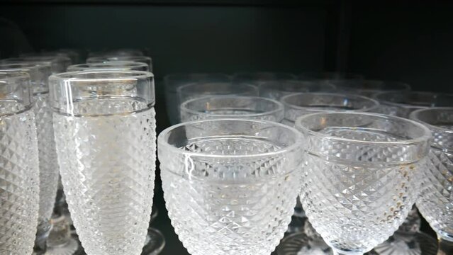 Close-up of many crystal glasses on a shelf