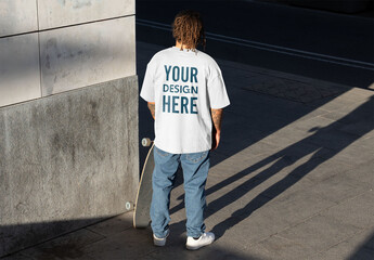Mockup of skater wearing customizable t-shirt and skateboard - obrazy, fototapety, plakaty