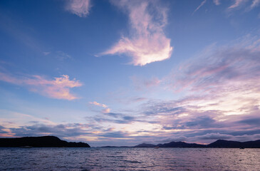 Beautiful blue landscape with sunset on the sea shore. Beautiful cloudy sky.