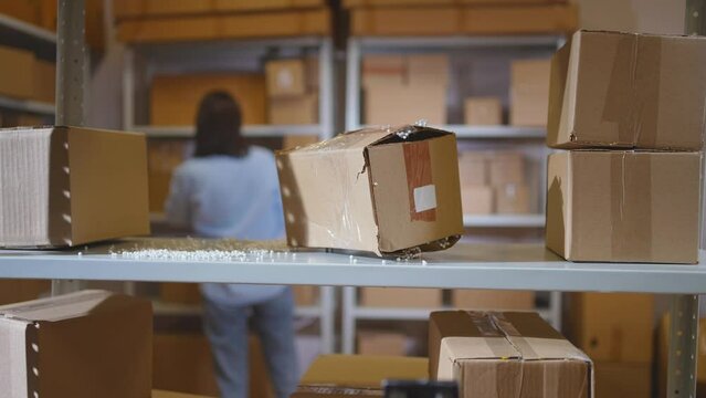 a lost parcel in a warehouse, against the background of a working person