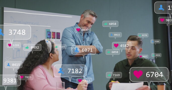 Image of notification bars over diverse coworkers discussing about product design in office